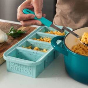 A person scooping leftovers into Souper Cubes trays.